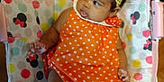 Tiani joined the competition — help win amazing prizes! baby, baby_chair, child, colorful, curious, cute, expression, flower, footwear, headband, indoors, infant, mickey_mouse, minnie_mouse, orange_dress, pattern, polka_dot, seated, socks, soft_toys