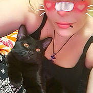 Sheik Moon is registered to the contest to win money with this photo: selfie, person, cat, black_cat, face_filter, heart, whiskers, close_up, cuddle, pet, indoor, blanket, pattern, necklace, lip_piercing, casual_clothing, cute, eyes, expression, portrait