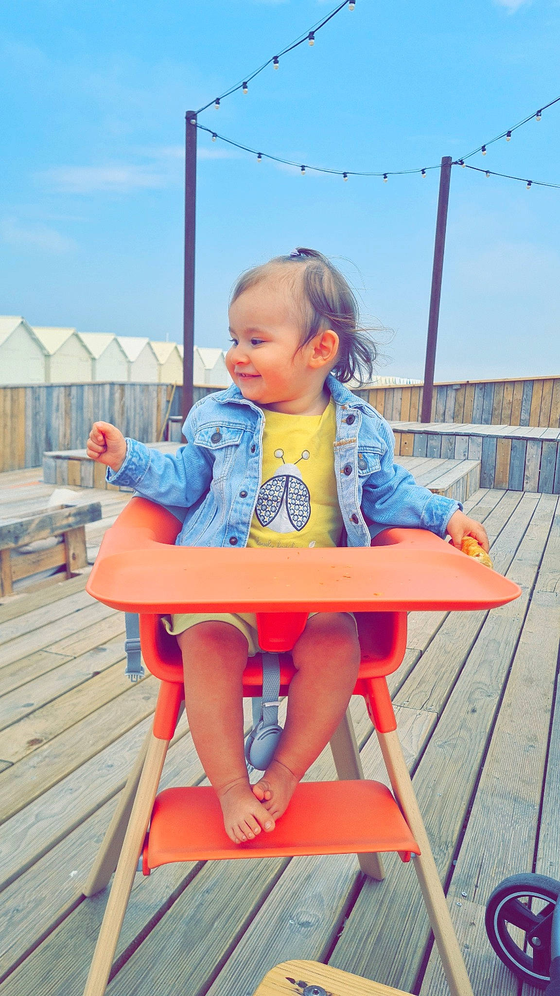 Mya participe au concours pour gagner de l'argent avec cette photo : baby, baby_toddler_clothing, child, cloud, comfort, electric_blue, fun, happy, joy, leisure, orange, outdoor_furniture, person, public_space, recreation, red, sitting, sky, smile, toddler