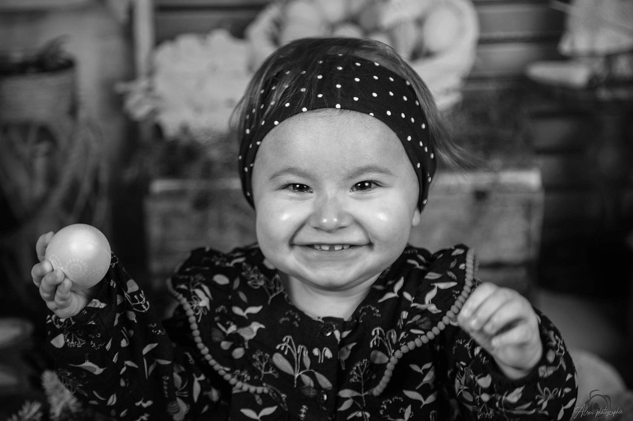 Mya participe au concours pour gagner de l'argent avec cette photo : baby, black, black_and_white, ear, eye, flash_photography, fun, hairstyle, happy, headgear, headwear, iris, joy, monochrome_photography, organ, people, person, photograph, smile, standing