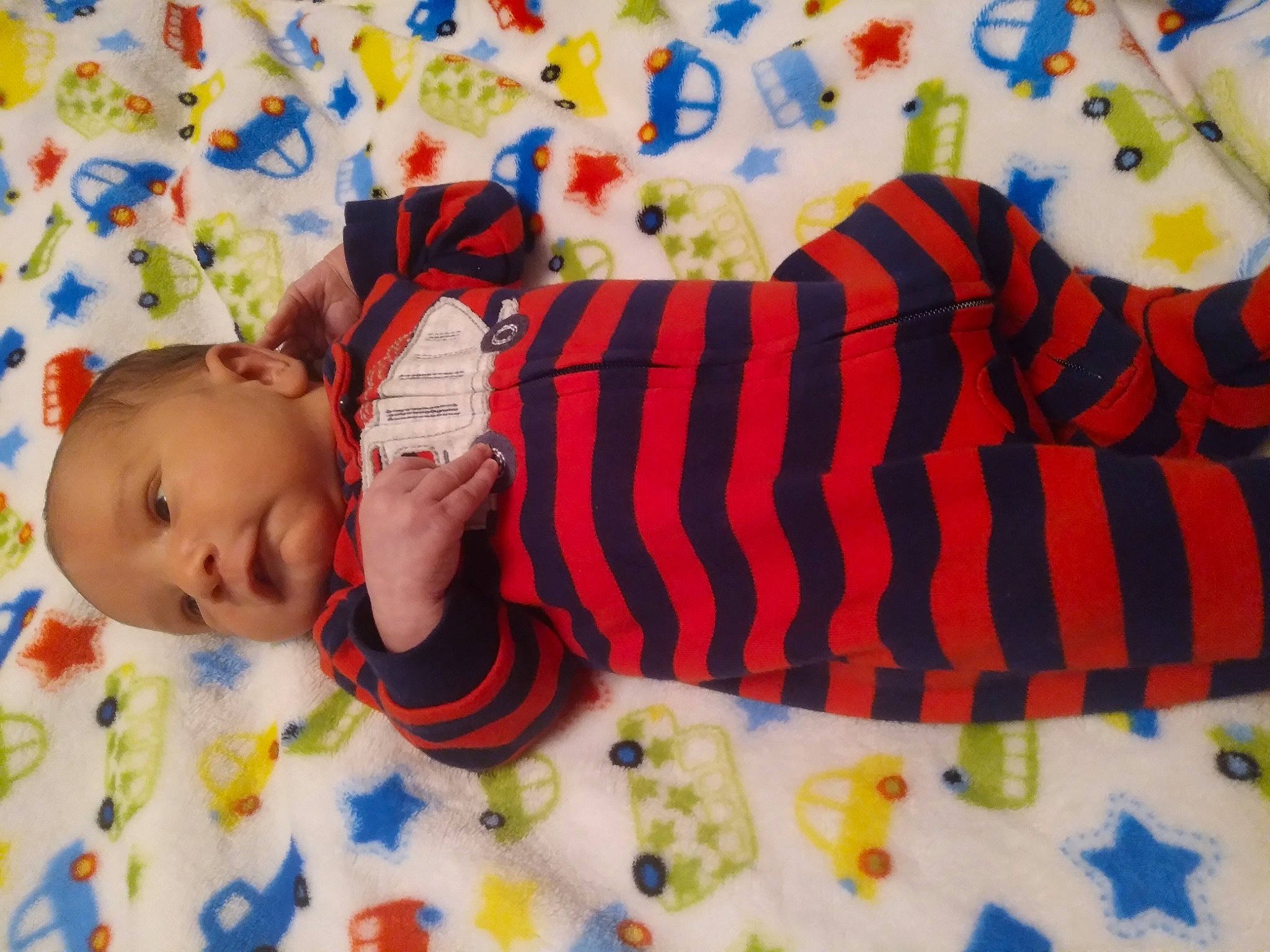 Lucius is registered to the contest to win money with this photo: arm, baby, baby_products, baby_toddler_clothing, baby_toys, child, comfort, design, hand, happy, headgear, linens, orange, pattern, person, play, room, sleeve, textile, toddler