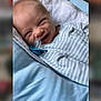 Zachary joined the competition — help win amazing prizes! baby, infant, smiling, face, blanket, blue, white, clothing, pacifier, happy, cute, newborn, lying_down, striped, soft, indoors, child, person, cozy, toddler