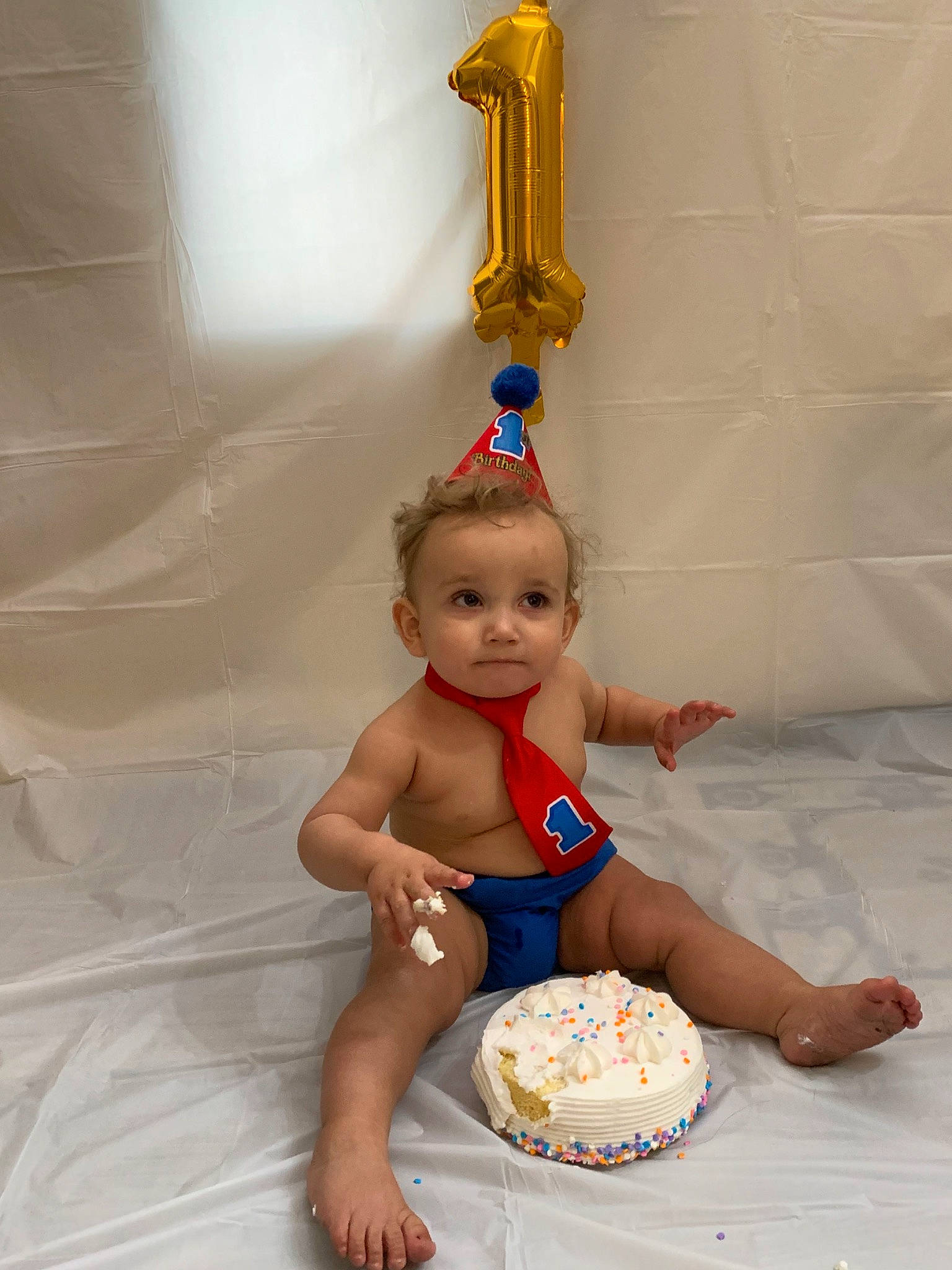 Trenton is registered to the contest to win money with this photo: baby, bathing, cake, child, person, sitting, toddler