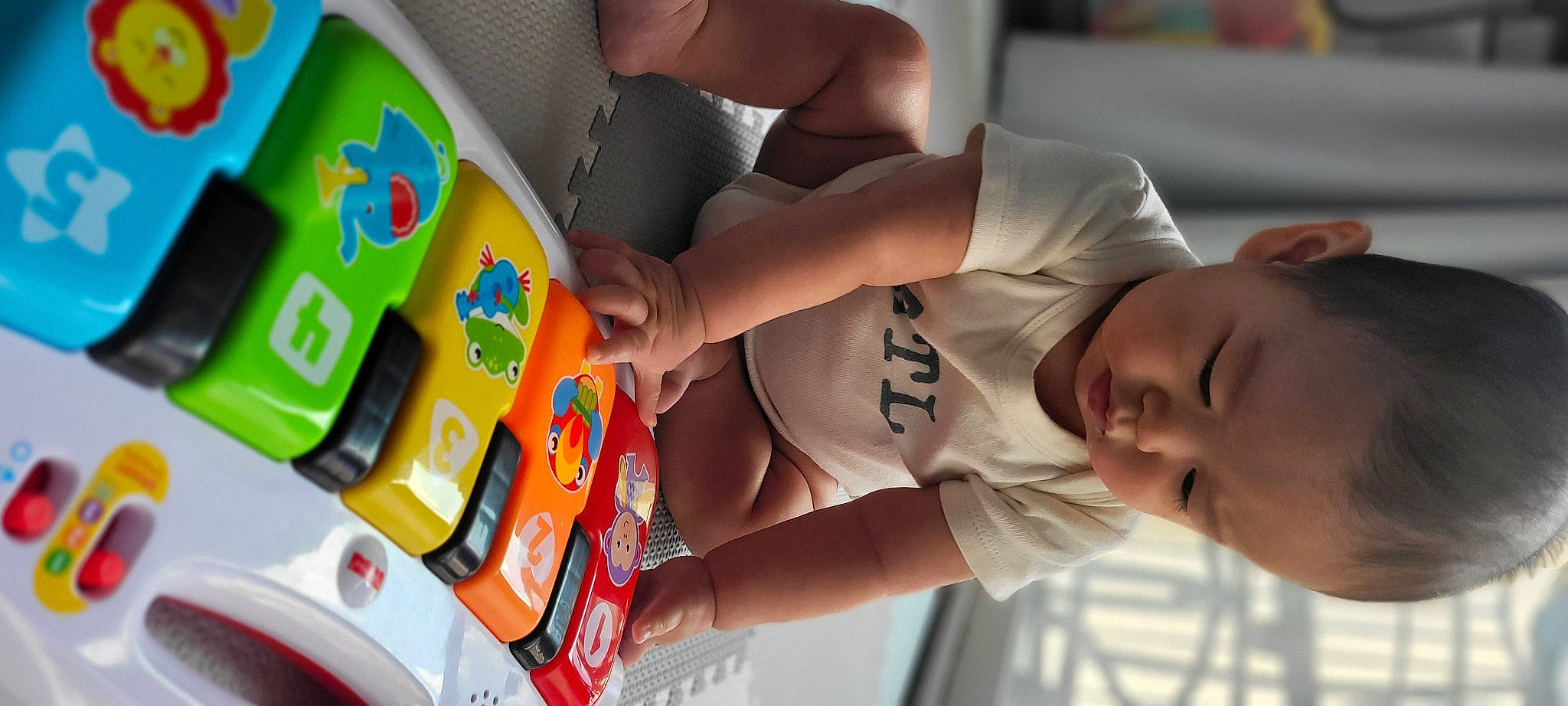 Camden is registered to the contest to win money with this photo: baby, child, finger, fun, gadget, games, hand, learning, nail, orange, person, plastic, play, recreation, room, t_shirt, thumb, toddler, toy, wrist