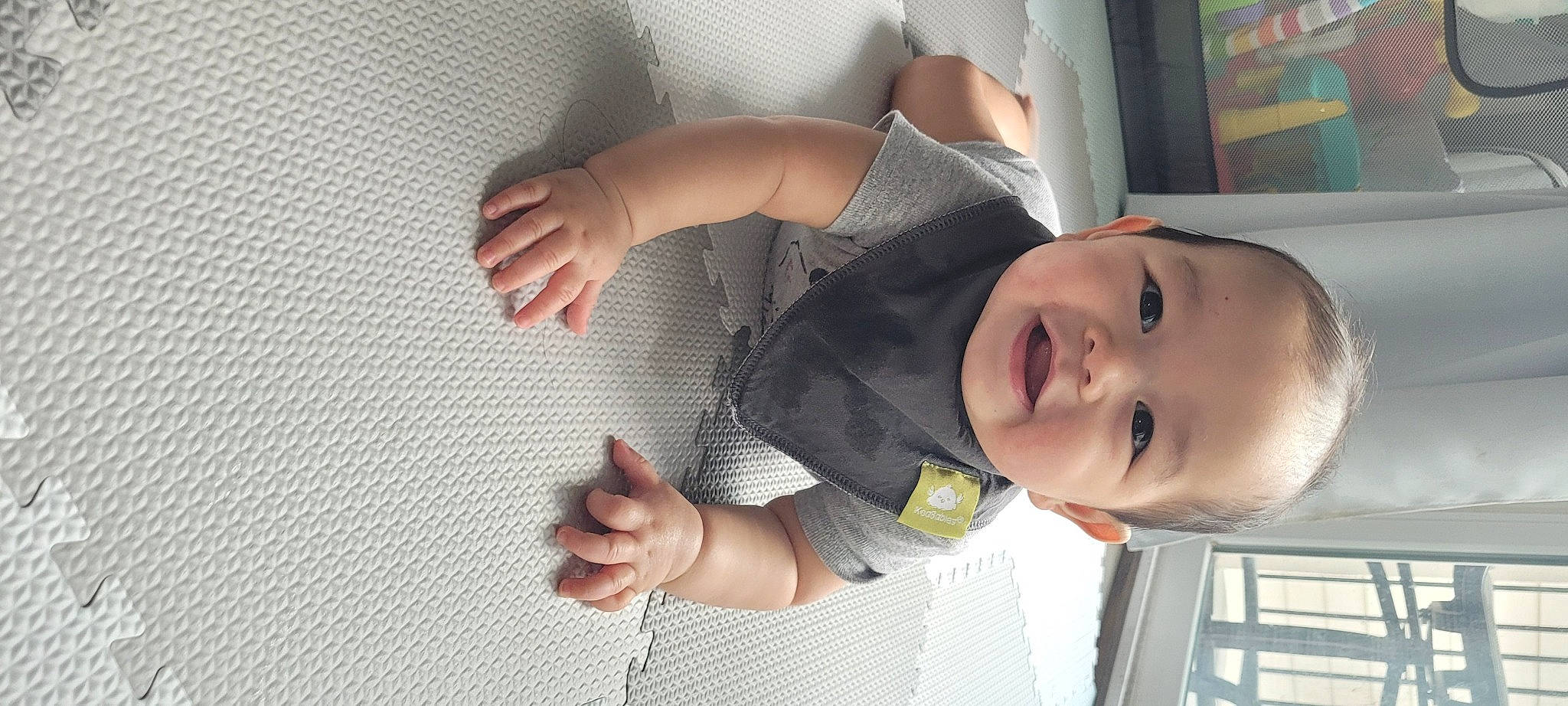 Camden is registered to the contest to win money with this photo: baby, baby_toddler_clothing, cheek, child, comfort, elbow, facial_expression, finger, fun, gesture, happy, mouth, nose, person, plant, skin, sleeve, smile, standing, thumb