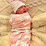newborn, baby, swaddle, pink, animal_print, hat, soft_blanket, cozy, cute, infant, sleeping, resting, portrait, child, warm, fuzzy, headwear, wrapped, peaceful, indoors