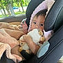 Yareli is registered to the contest to win money with this photo: baby, car_seat, stuffed_animal, blanket, child, infant, toy, seatbelt, window, trees, car_interior, soft_toy, cute, hand_gesture, plush, child_seat, cozy, indoors, person, portrait