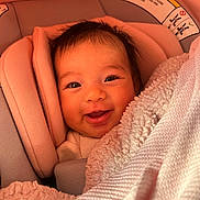 Yareli joined the competition — help win amazing prizes! baby, smiling, car_seat, blanket, infant, cute, face, child, happy, cozy, wrapped, portrait, young, seat, indoors, warm, blanket_texture, head_support, expression, adorable