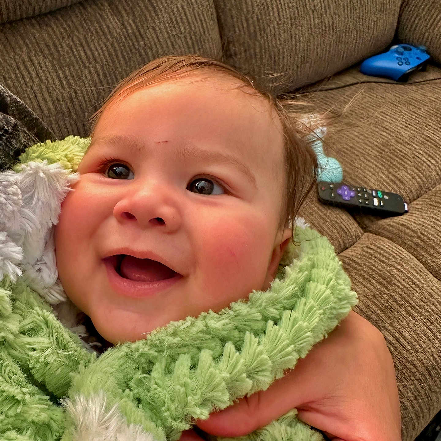 Halston joined the competition — help win amazing prizes! baby, blanket, clothing, coat, couch, cushion, electronics, face, furniture, happy, head, homedecor, jacket, laughing, person, photography, portrait, remotecontrol, scarf, smile