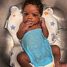 baby, infant, child, bath, sink, water, towel, curly_hair, skin, face, hand, foot, star_pattern, baby_bath_seat, blue_towel, wet, cute, looking_at_camera, indoor, portrait