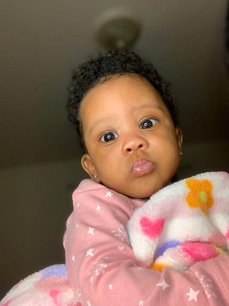 Dessiah is registered to the contest to win money with this photo: baby, baby_toddler_clothing, cheek, chin, eye, eyebrow, eyelash, face, hairstyle, happy, head, iris, lip, mouth, nose, outerwear, person, pink, skin, sleeve