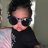 Bryson joined the competition — help win amazing prizes! adult, baby, black_shirt, casual_wear, child, close_up, cool, curly_hair, cute, eyewear, face, fashion, hand, indoor, person, portrait, reaching, sunglasses, tie_dye, toddler