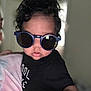 toddler, child, sunglasses, black_shirt, curly_hair, indoor, person, fashion, portrait, cute, baby, hand, reaching, tie_dye, adult, casual_wear, close_up, face, eyewear, cool