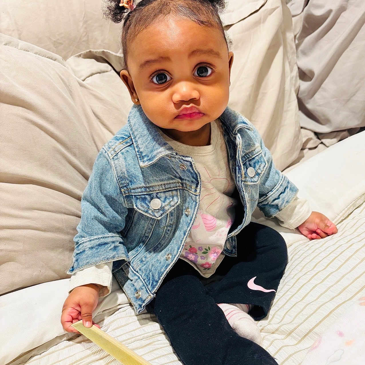 Nova joined the competition — help win amazing prizes! toddler, child, denim_jacket, comb, bed, pillow, curly_hair, hair_clips, socks, pants, sitting, indoors, cute, portrait, baby, expression, person, clothing, furniture, cozy