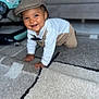 Kayden participe au concours pour gagner de l'argent avec cette photo : baby, child, crawling, smiling, hat, flat_cap, carpet, indoor, furniture, couch, clothing, person, happy, cute, headwear, toddler, home, floor, portrait, fashion