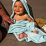 baby, child, towel, blue_towel, hooded_towel, smiling, happy, sitting, bare_chest, feet, couch, blanket, hand, indoor, cozy, portrait, cute, person, infant, family