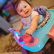 Daeneris is registered to the contest to win money with this photo: baby, carpet, child, clothing, colorful, cute, floor, furniture, hand, happy, head, indoor, infant, pattern, person, playtime, seat, smile, toy, walker