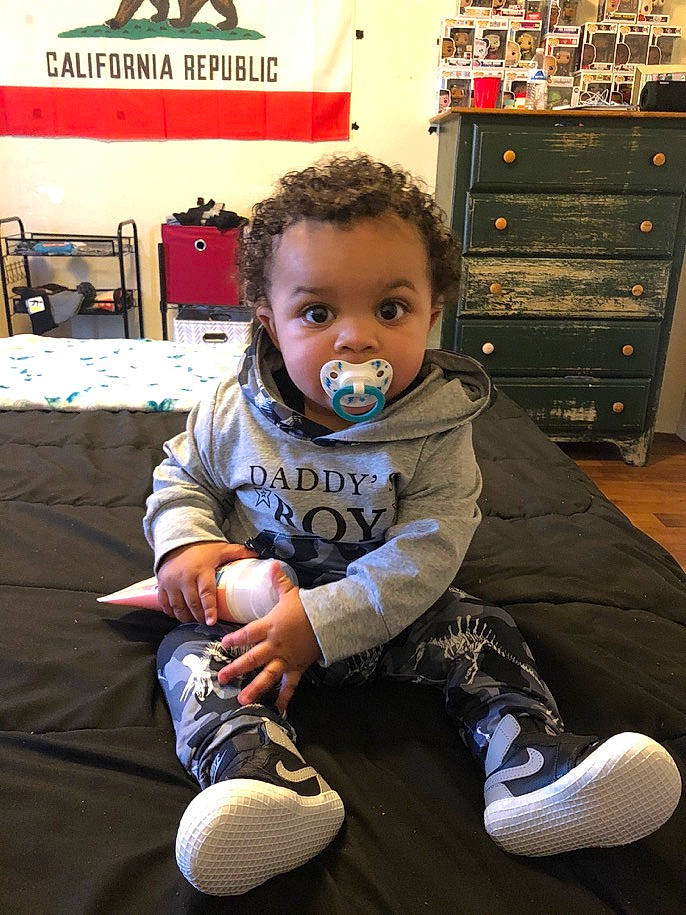 Zamari is registered to the contest to win money with this photo: baby, baby_toddler_clothing, boot, cabinetry, child, drawer, flooring, fun, hairstyle, happy, knee, lap, person, play, room, sitting, sleeve, sock, standing, toddler