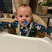 Anthony joined the competition — help win amazing prizes! baby, child, cozy, curious, decor, evening, face, furniture, high_chair, holiday_theme, home, indoor, infant, pacifier, pajamas, plant, potted_plant, seated, table, window