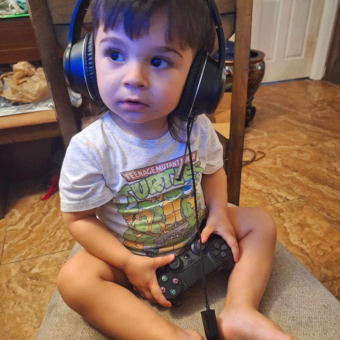 Chrissy is registered to the contest to win money with this photo: art, baby, bodypart, camera, couch, electronics, face, finger, furniture, hand, hardwood, head, headphones, painting, person, photography, plywood, portrait, sitting, wood