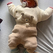 Kayden participe au concours pour gagner de l'argent avec cette photo : baby, newborn, pacifier, knitwear, hat, sleeping, bed, blanket, soft, cute, child, infant, cozy, clothing, footwear, sleep, rest, indoors, person, toddler