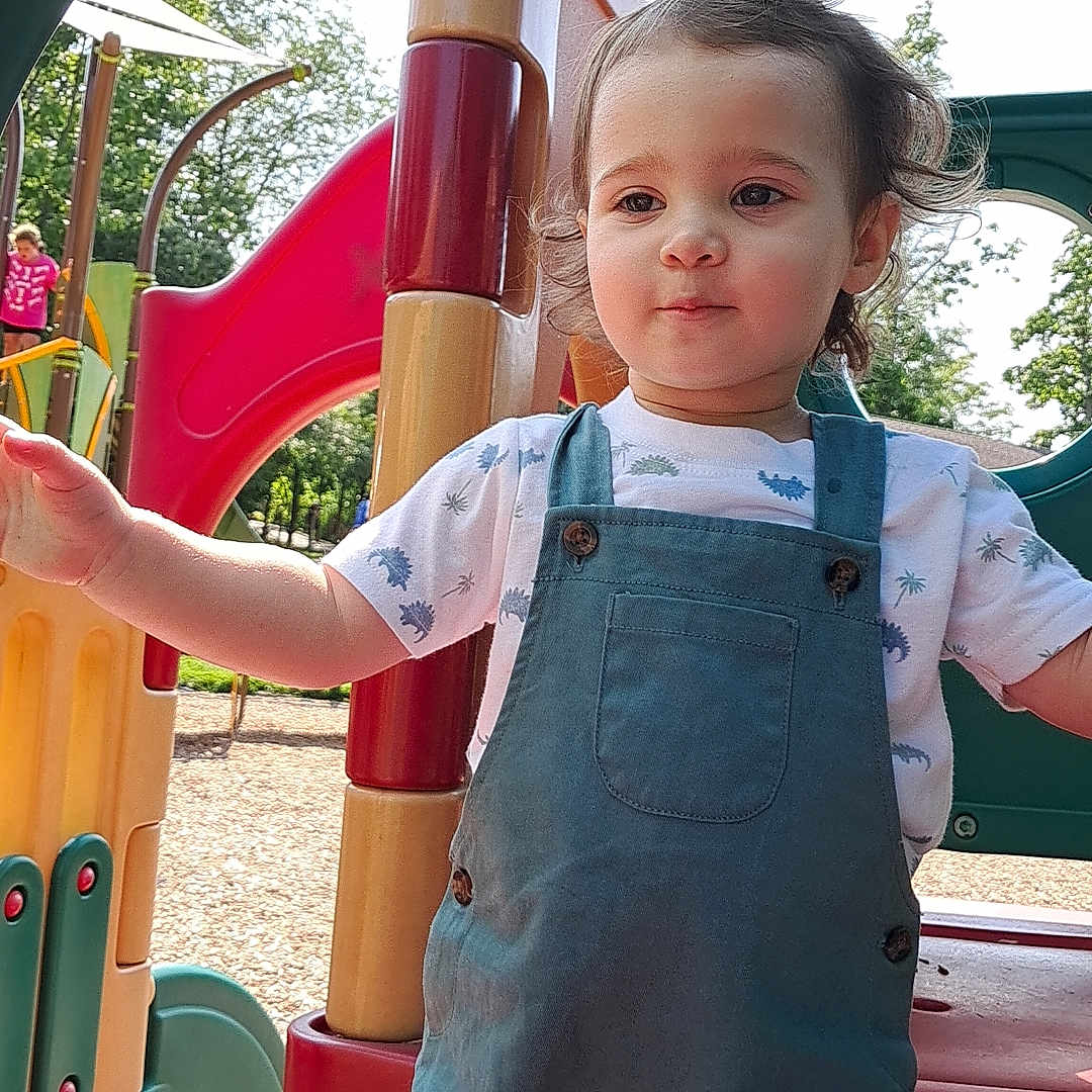 Sadie is registered to the contest to win money with this photo: baby, bodypart, clothing, dynamite, face, finger, hand, head, jeans, kindergarten, outdoorplayarea, outdoors, pants, person, playarea, shorts, slide, toy, weapon, wood