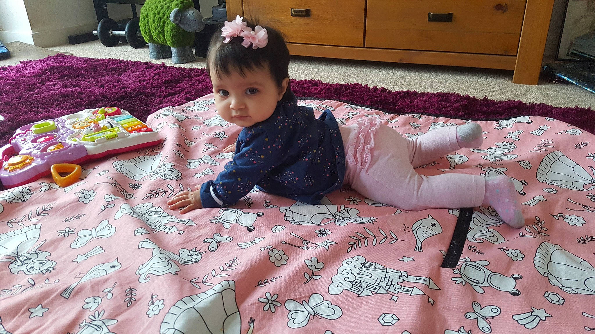 Ayra is registered to the contest to win money with this photo: bed, bed_sheet, bedding, child, day, flooring, flower, girl, infant, linens, material, person, pink, play, product, skin, textile, toddler