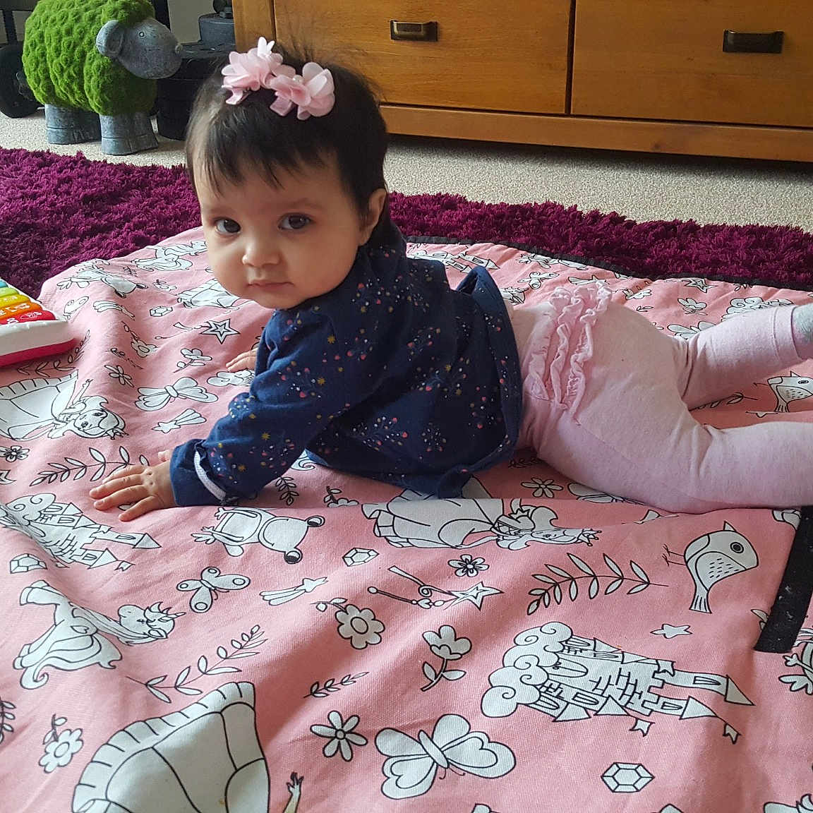 Ayra is registered to the contest to win money with this photo: bed, bed_sheet, bedding, child, day, flooring, flower, girl, infant, linens, material, person, pink, play, product, skin, textile, toddler