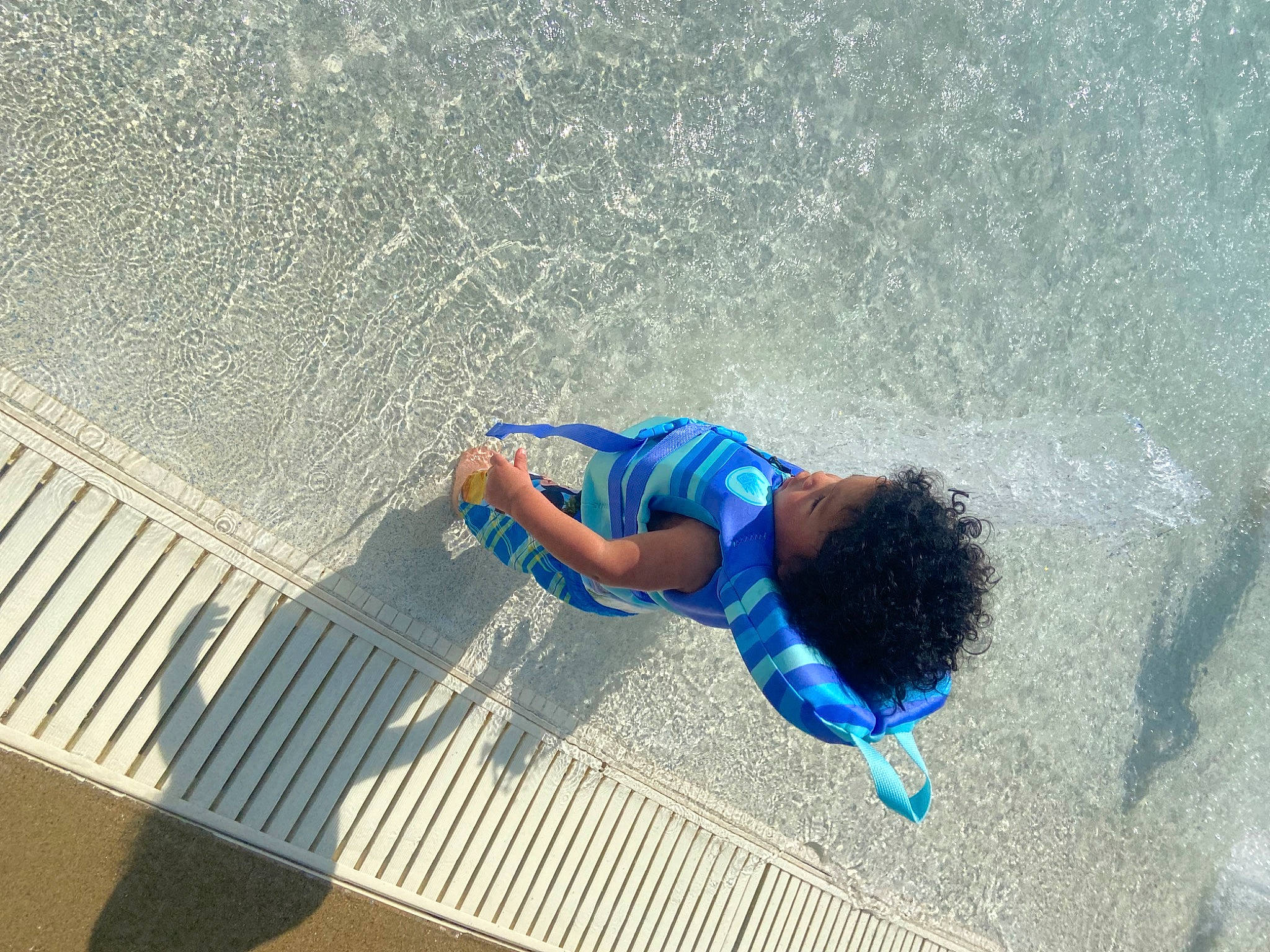 Jayden Jason Lewis is registered to the contest to win money with this photo: azure, barefoot, beach, concrete, electric_blue, foot, fun, human_leg, leisure, ocean, pattern, person, shadow, thigh, toddler, water, wind_wave, wood