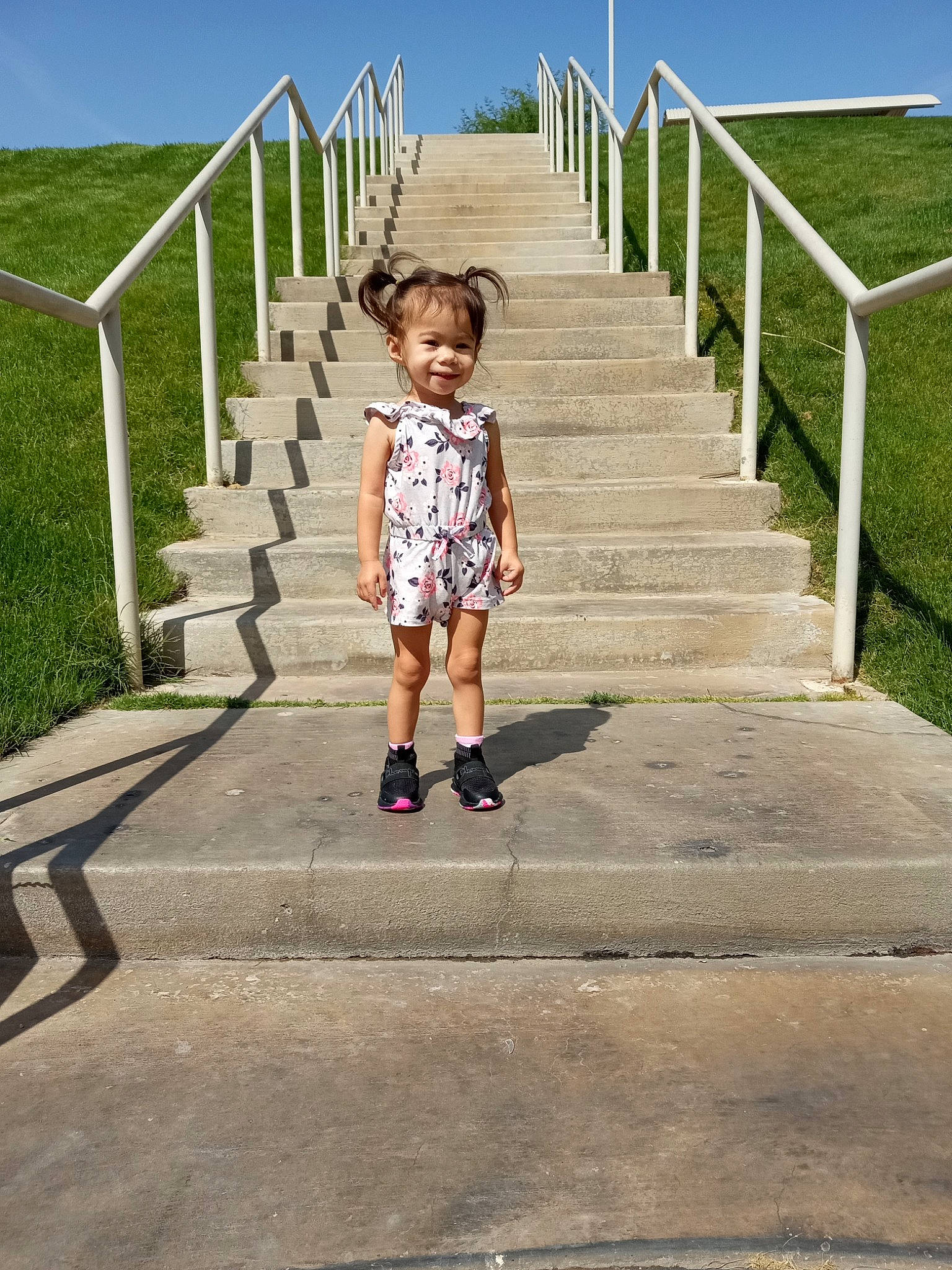 Kaliyah is registered to the contest to win money with this photo: boardwalk, child, fence, grass, handrail, happy, horizon, joy, landscape, leisure, pattern, pedestrian, people_in_nature, person, plant, recreation, sky, stairs, symmetry, toddler