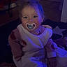 baby, blanket, blue_light, child, childcare, clothing, comfort, cute, face, floor, hair, home, indoor, infant, pacifier, sitting, smile, toddler, toy, young_child