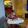 baby_walker, child, cozy, cushion, door, floor_tiles, furniture, happy, home, indoor, lamp, living_room, person, playtime, plush_toy, purple_clothing, seated, smiling, toddler, toy