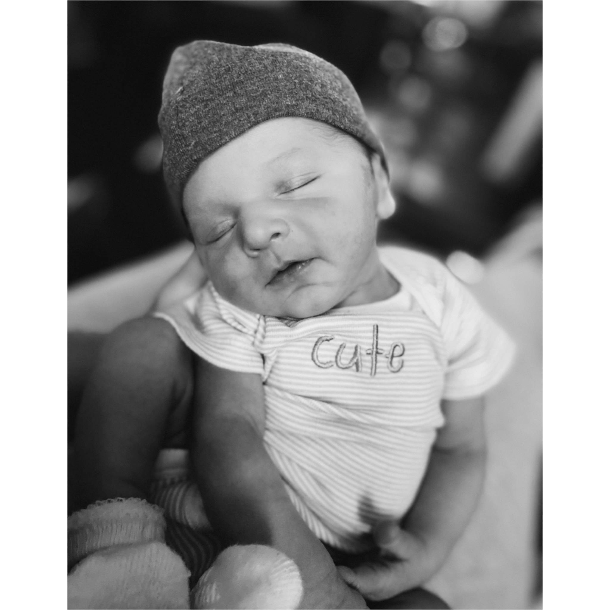 Kingston is registered to the contest to win money with this photo: arm, baby, baby_sleeping, black, black_and_white, cap, cheek, chin, comfort, eye, finger, flash_photography, gesture, hand, happy, headwear, human_body, nose, person, skin