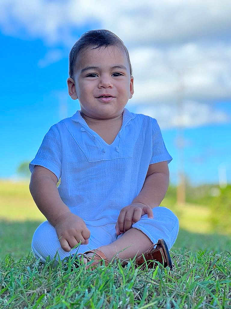 Daniel De Jesús joined the competition — help win amazing prizes! baby, blue_sky, casual, child, clouds, cute, daylight, footwear, grass, greenery, happy, nature, outdoor, portrait, sitting, smiling, sunny, toddler, white_clothing, youth
