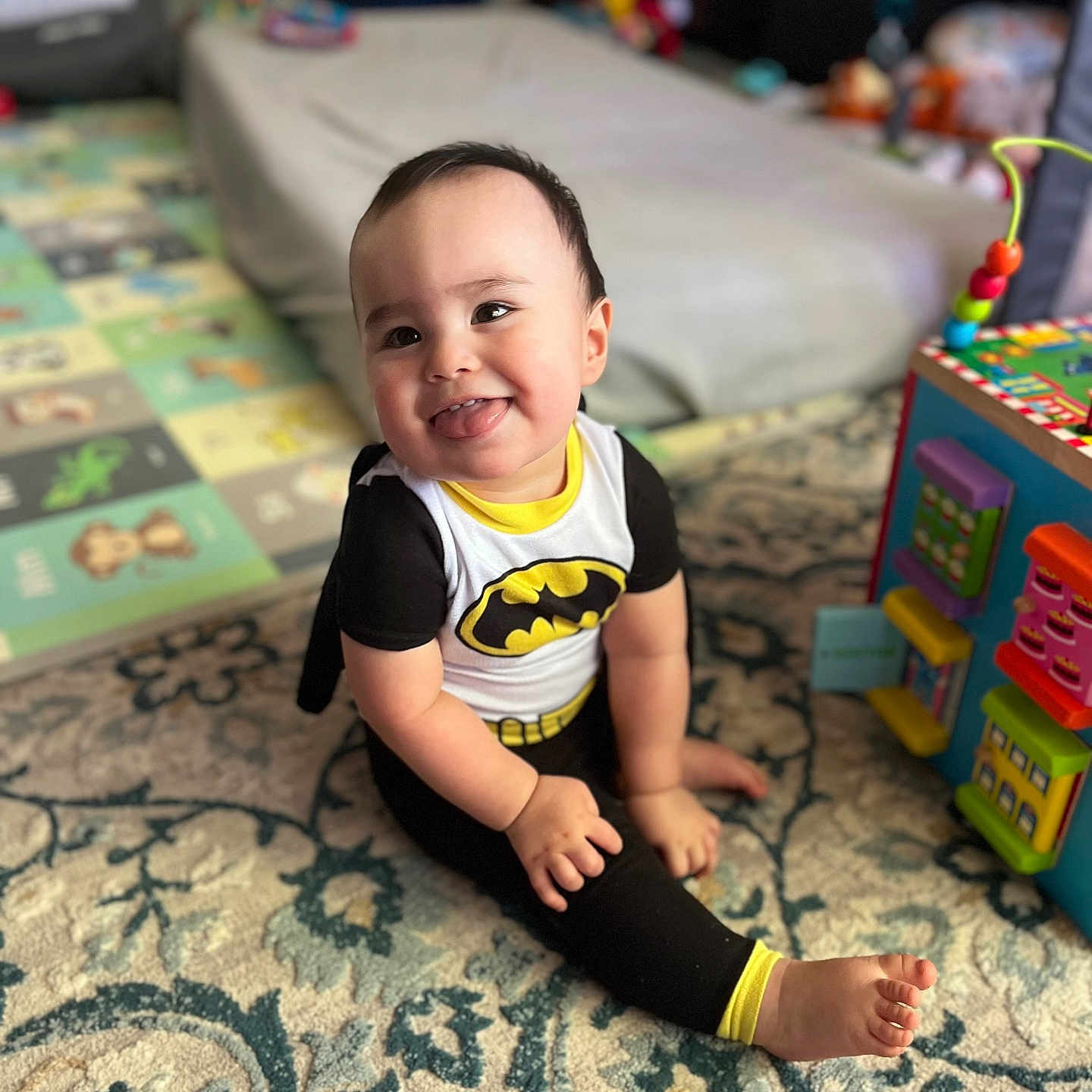 Caelan is registered to the contest to win money with this photo: architecture, baby, bed, bedroom, building, clothing, couch, cushion, face, furniture, happy, head, homedecor, indoors, person, photography, portrait, room, sitting, t_shirt