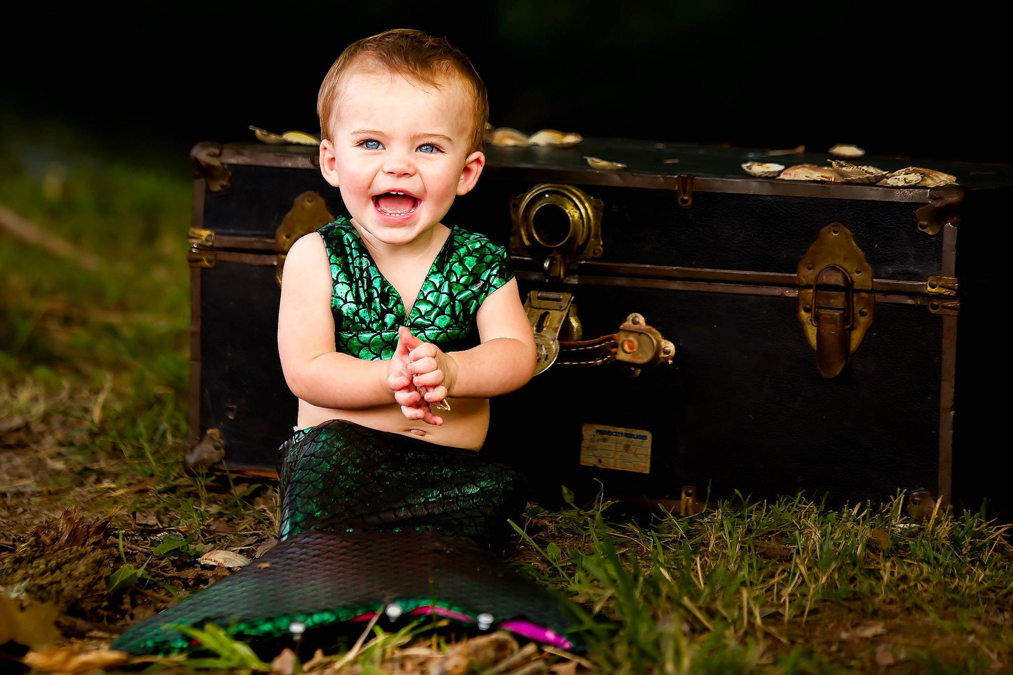 Mckinley is registered to the contest to win money with this photo: baby, baby_toddler_clothing, blond, child, eye, flash_photography, fun, grass, grassland, hairstyle, happy, head, iris, leisure, people_in_nature, person, plant, sitting, smile, toddler