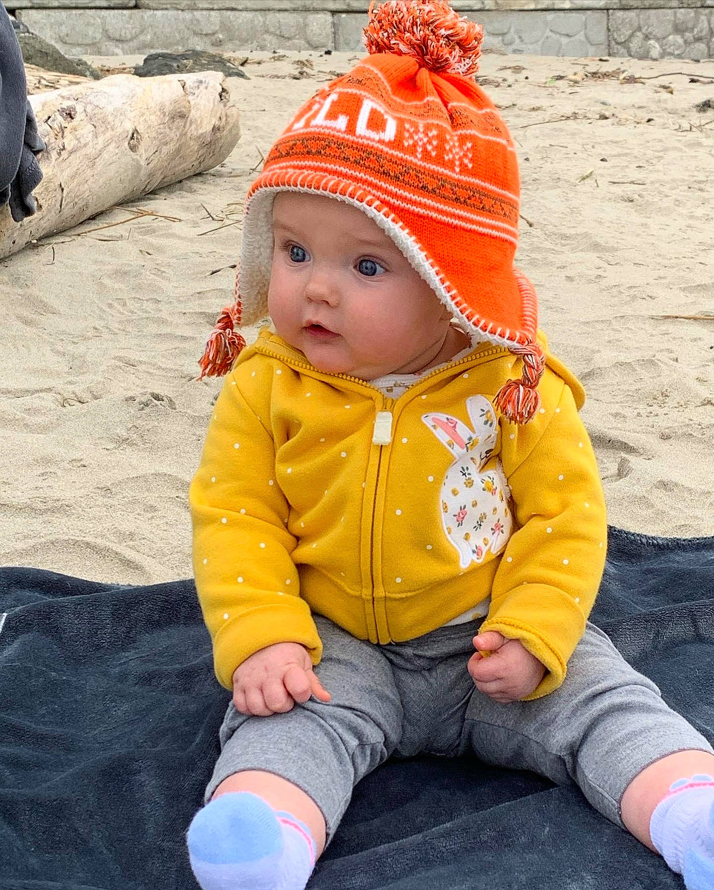 Tatum joined the competition — help win amazing prizes! baby, baby_toddler_clothing, cap, cheek, child, fashion_accessory, fun, grass, happy, headwear, knit_cap, leisure, orange, people_in_nature, person, personal_protective_equipment, play, recreation, sitting, skin
