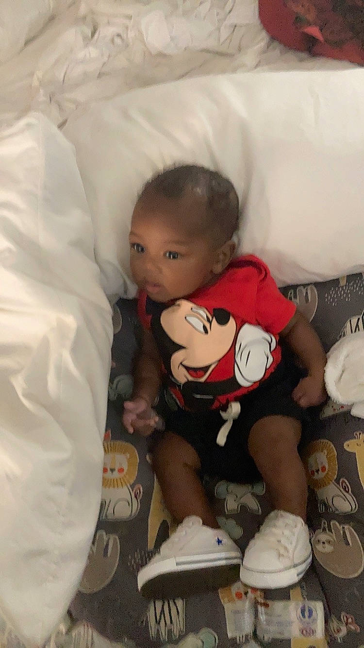 Cassius is registered to the contest to win money with this photo: abdomen, baby, baby_products, baby_sleeping, bed, bedding, carmine, child, comfort, fun, hat, linens, person, pillow, room, sleeve, t_shirt, thigh, toddler, toy