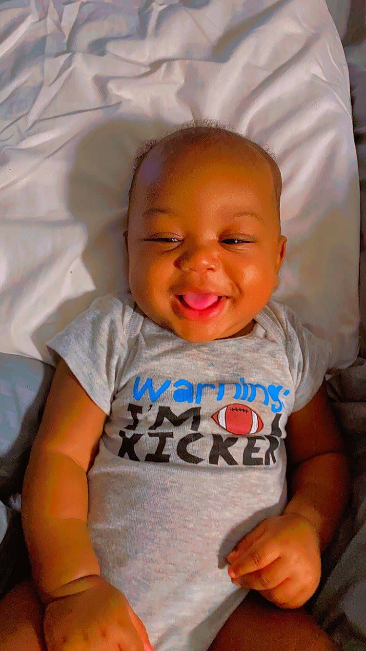 Cassius is registered to the contest to win money with this photo: baby_toddler_clothing, cheek, chin, comfort, eye, eyebrow, face, facial_expression, happy, head, iris, lip, mouth, nose, orange, person, product, skin, sleeve, smile