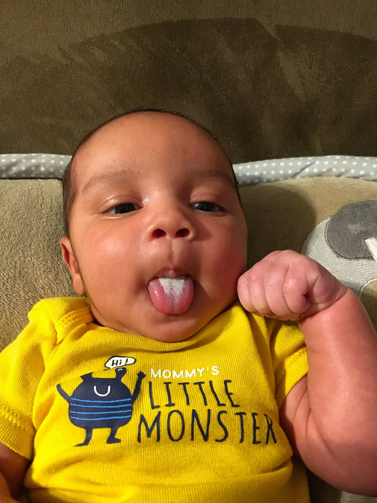 Carson is registered to the contest to win money with this photo: baby, baby_making_funny_faces, cheek, child, face, facial_expression, head, mouth, nose, person, smile, toddler, yellow