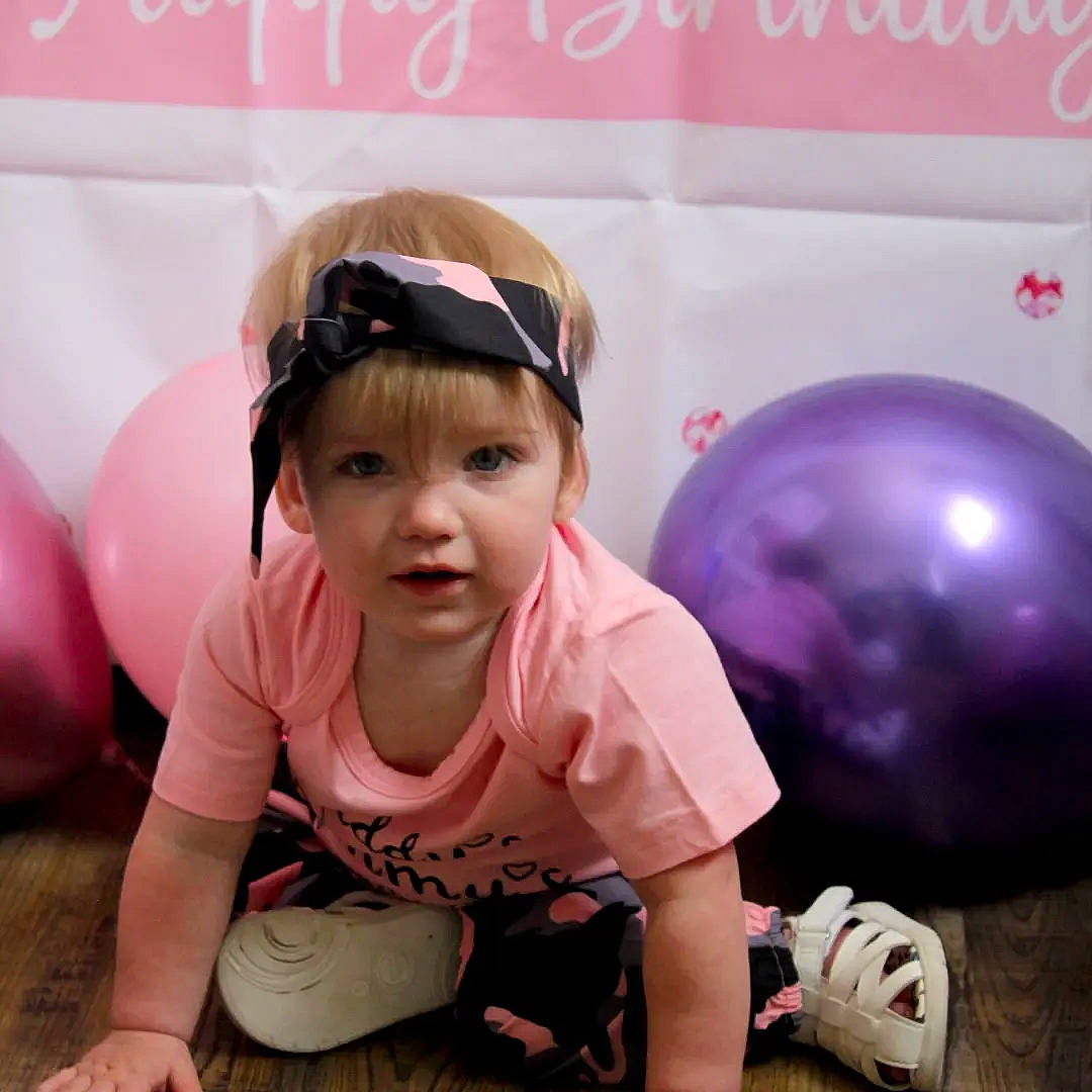 Jacklynn is registered to the contest to win money with this photo: baby_toddler_clothing, balloon, eyewear, flooring, fun, glasses, goggles, happy, headwear, leisure, magenta, person, pink, recreation, shorts, sleeve, sunglasses, thigh, thumb, toddler