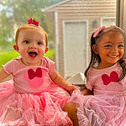 Ellieanna joined the competition — help win amazing prizes! child, two_girls, pink_dress, tutu, smiling, happy, window, natural_light, holding_hands, cute, baby, toddler, indoor, girl, hair_bow, playful, portrait, childhood, friendship, fashion