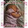 baby, sleeping, infant, blanket, mittens, striped_clothing, pink, soft_texture, cozy, portrait, cute_border, floral_border, heart_decorations, closeup, resting, peaceful, indoors, newborn, sleepwear, child