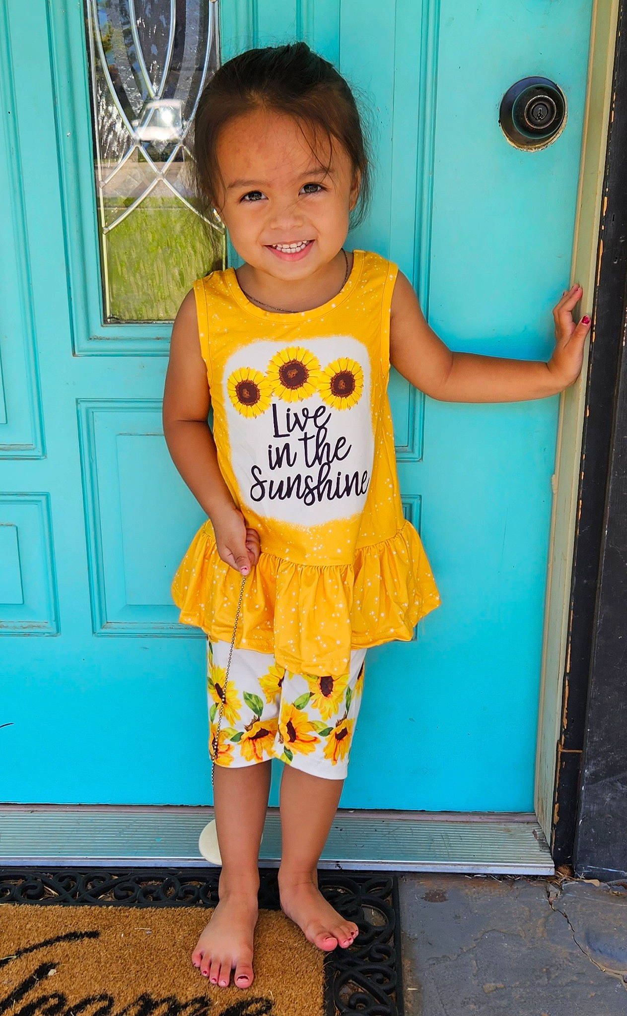 Skylan is registered to the contest to win money with this photo: baby_toddler_clothing, blue, child, door, dress, electric_blue, green, happy, joint, joy, orange, pattern, person, pink, sleeve, smile, standing, t_shirt, thigh, toddler
