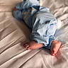 Cj is registered to the contest to win money with this photo: baby, feet, blue_clothing, pajamas, bed, blanket, sleeping, infant, soft, cozy, cute, child, rest, home, fabric, skin, toes, lying_down, comfort, nap