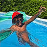 blue_sky, casual, child, fun, greenery, inflatable_pool, outdoor, playful, pool, red_cap, relaxation, splash, summer, sunglasses, sunlight, sunny, swimming, vacation, water, youth