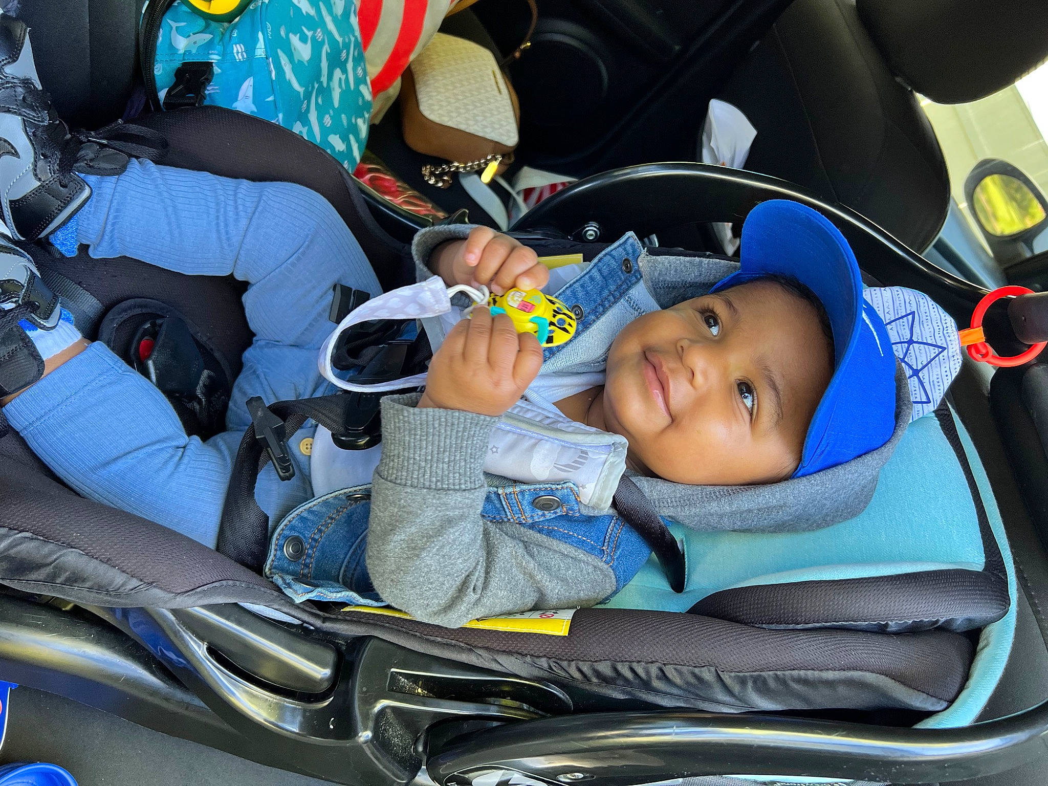 Cairo is registered to the contest to win money with this photo: auto_part, automotive_design, automotive_exterior, baby_carriage, baby_products, blue, car_seat, car_seat_cover, child, comfort, electric_blue, fun, head_restraint, headwear, joy, lap, motor_vehicle, person, smile, steering_part