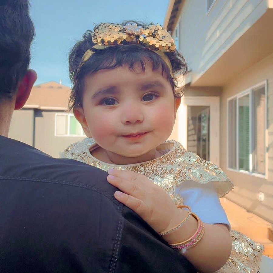 Hafsa Saad joined the competition — help win amazing prizes! adult, backyard, bracelets, child, curly_hair, cute, daylight, face, family, gold_bow, gold_dress, happy, holding, house, outdoor, person, portrait, smile, toddler, window