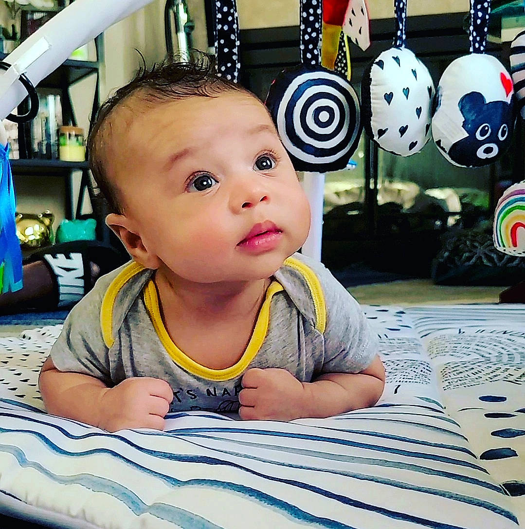 Dante joined the competition — help win amazing prizes! baby, baby_toddler_clothing, blue, cheek, child, chin, cool, eye, flooring, fun, happy, leisure, person, product, sitting, snapshot, t_shirt, tire, toddler, wheel