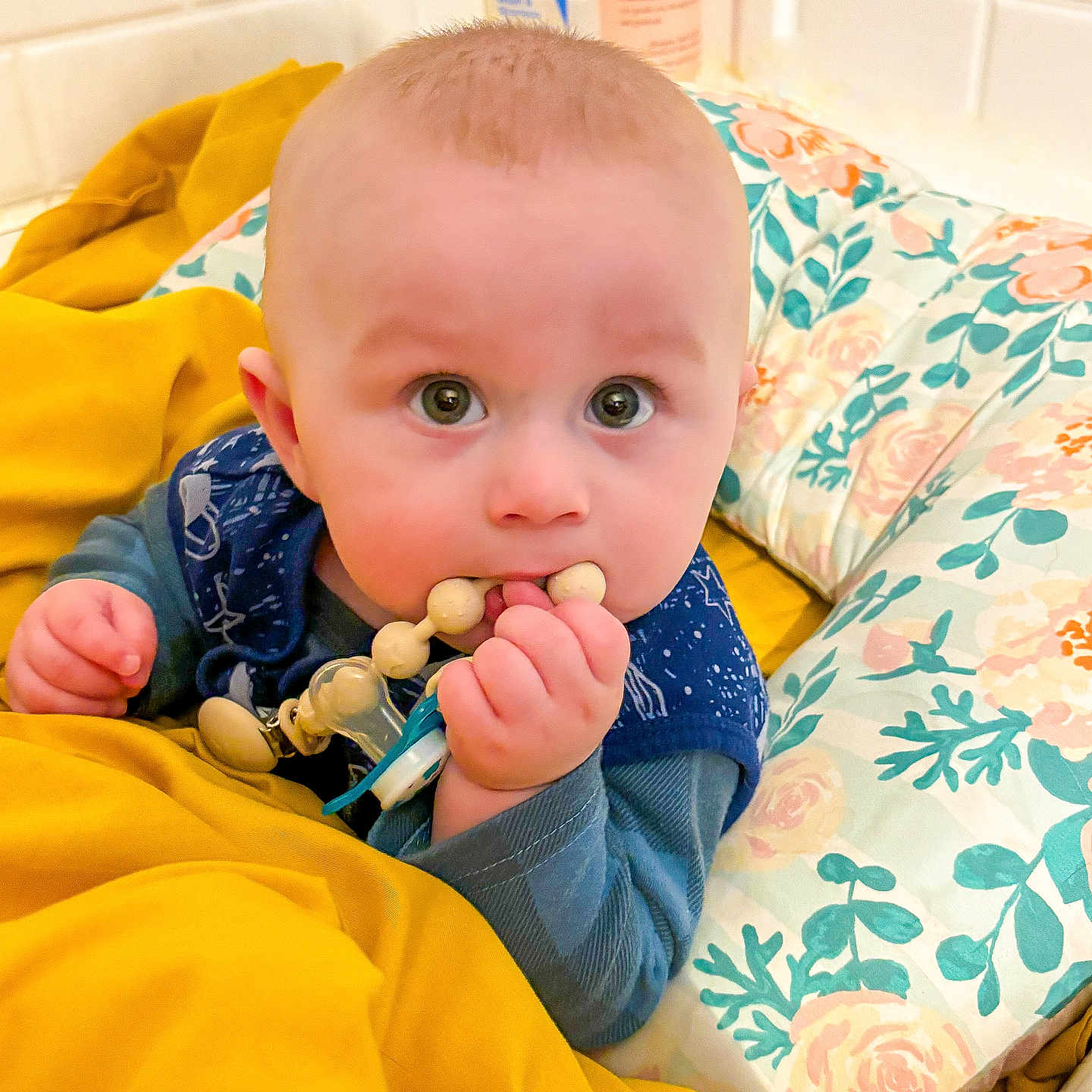 Lucien is registered to the contest to win money with this photo: baby, bed, bedroom, bodypart, couch, cushion, eating, face, finger, food, furniture, hand, head, homedecor, indoors, person, photography, portrait, room, toy